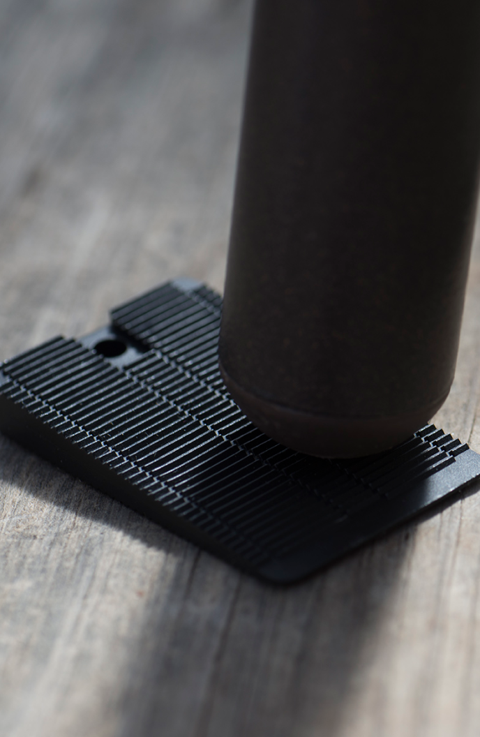 Wobble Wedge being used underneath a table leg