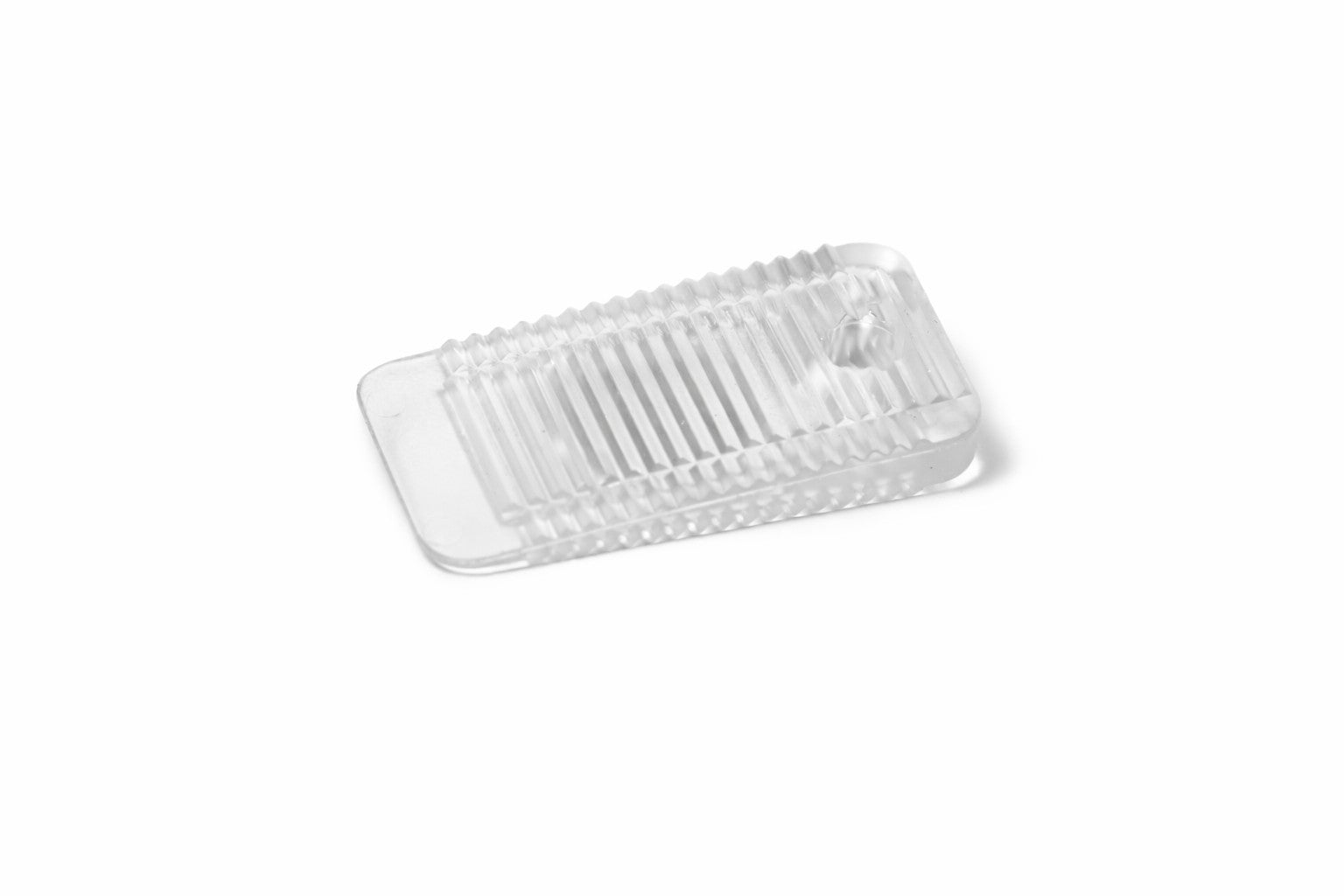Detailed view of a clear mini Wobble Wedge on a white background